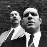 Moderator Liam with blonde hair wearing iron armor standing in a village